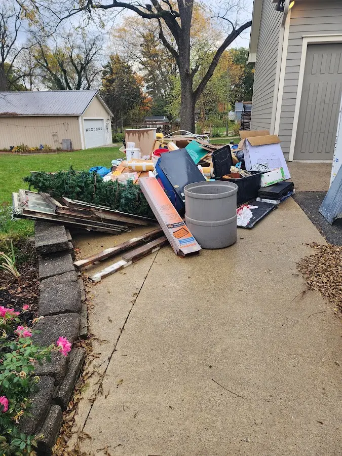 Dumpster being loaded with debris for Estate Cleanout Dumpster Rental in Larose